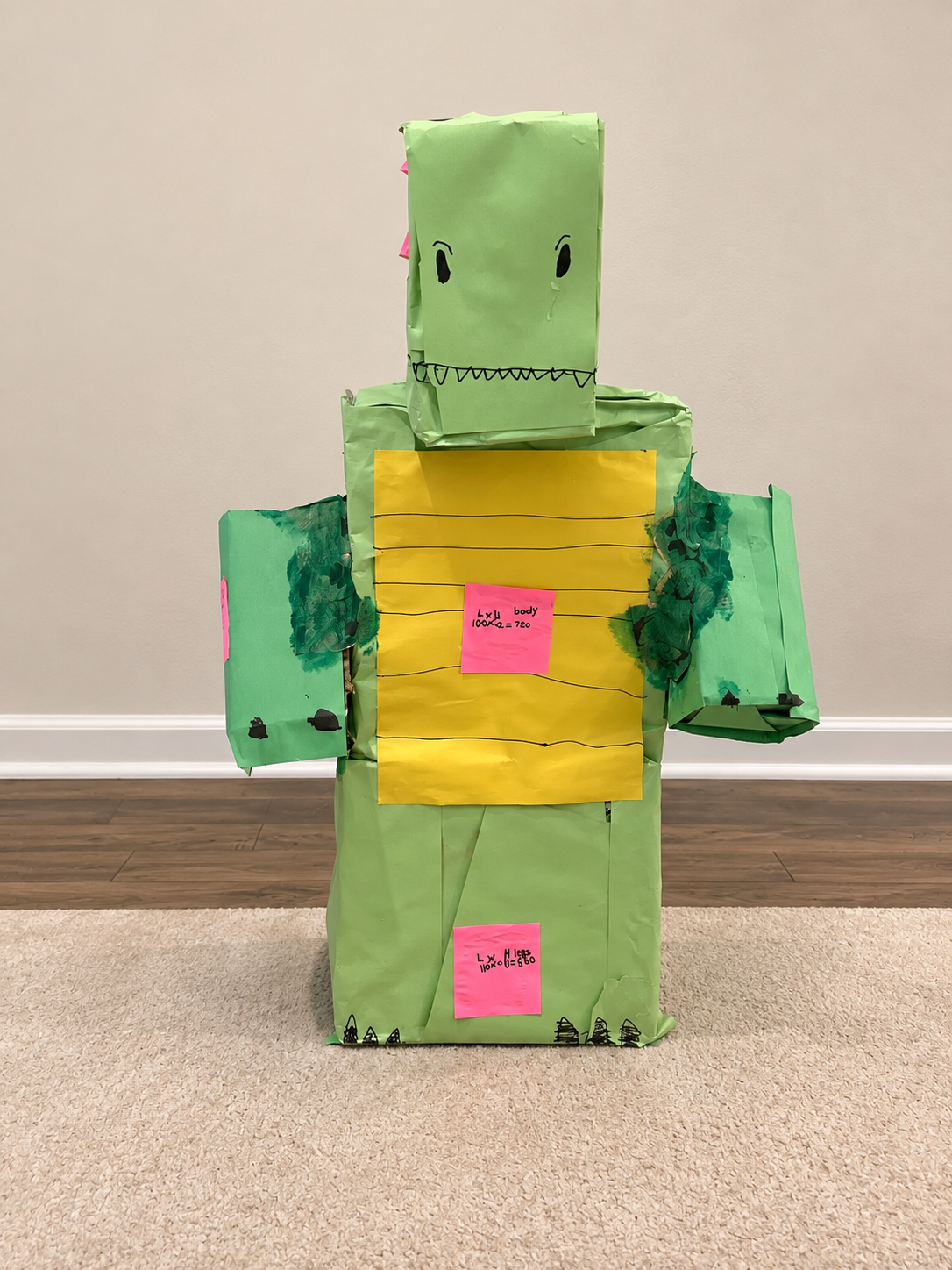 Green cardboard dinosaur built with rectangular prisms